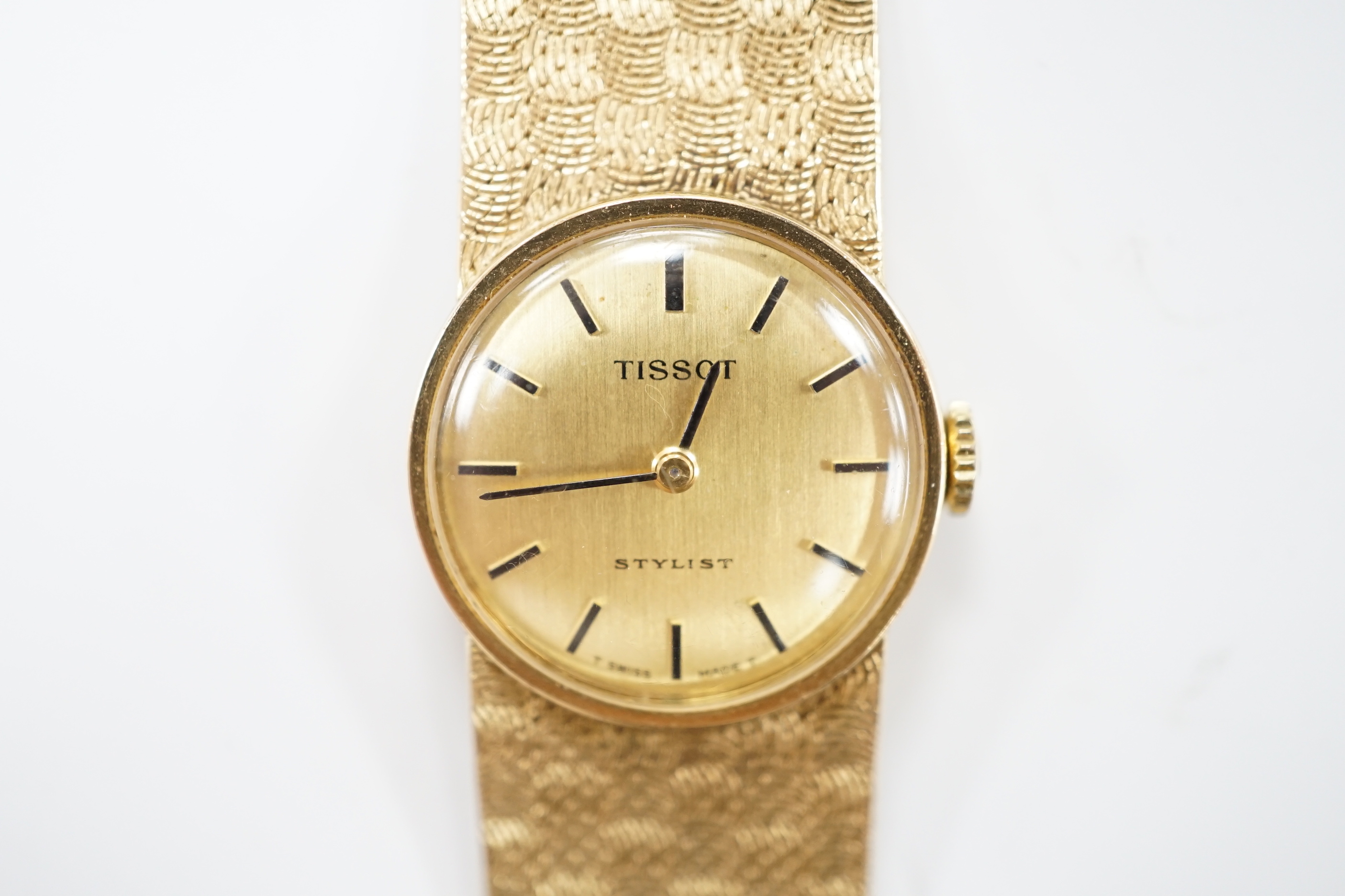 A lady's modern 9ct gold Tissot Stylist manual wind bracelet wrist watch, overall 16.5cm, gross weight 29.1 grams.